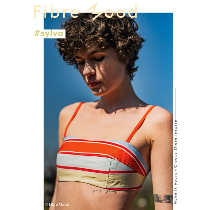 Woman wearing a striped bikini top with 'Fibre Mood' branding and '#sylva' hashtag.