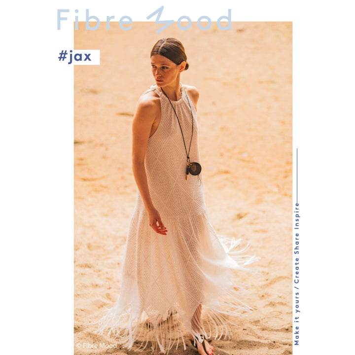 Woman wearing a white dress with fringe details in a desert setting, with 'Fibre Mood' branding.