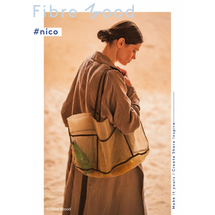 Person wearing a beige jacket with large pockets against a beige background, with 'Fibre Mood' branding.