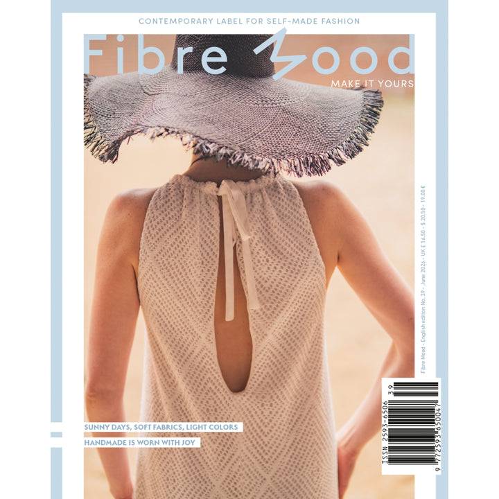 Magazine cover with a person wearing a textured dress and wide-brimmed hat, featuring 'fibre mood' branding.