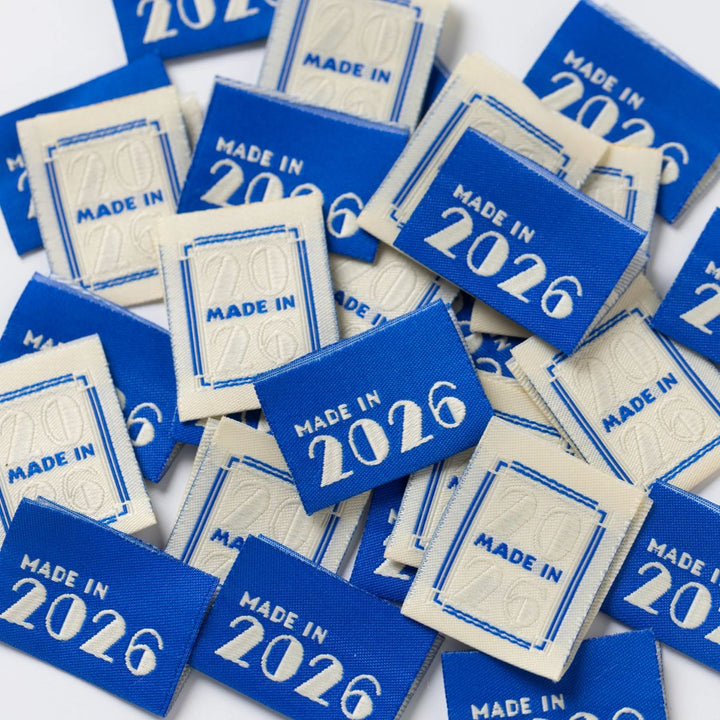 Collection of blue labels with 'Made in 2026' text on a white background