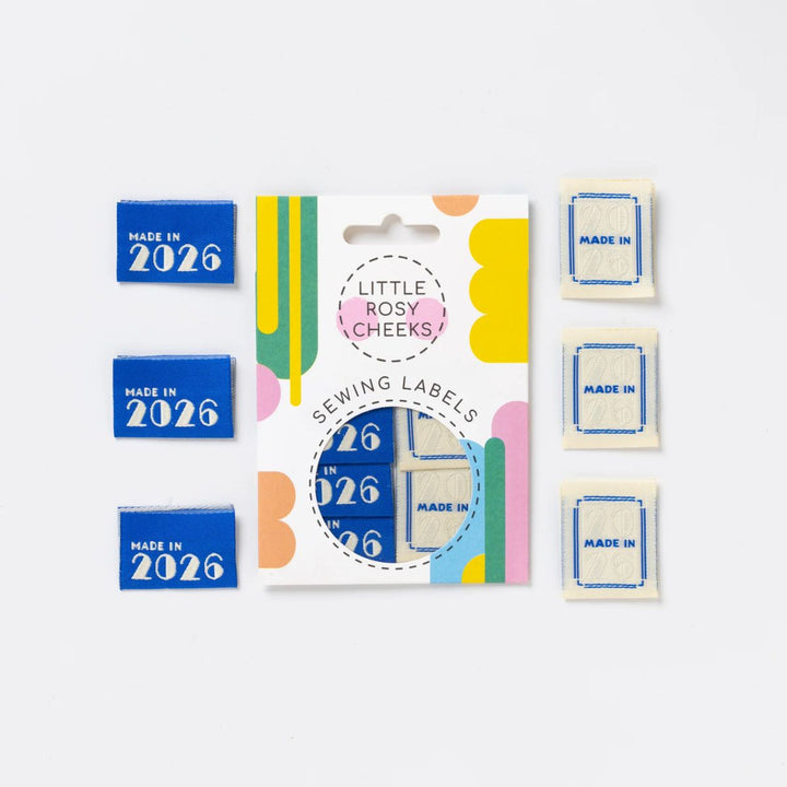 Collection of sewing labels with 'Made in 2026' and brand 'Little Rosy Cheeks' on a white background