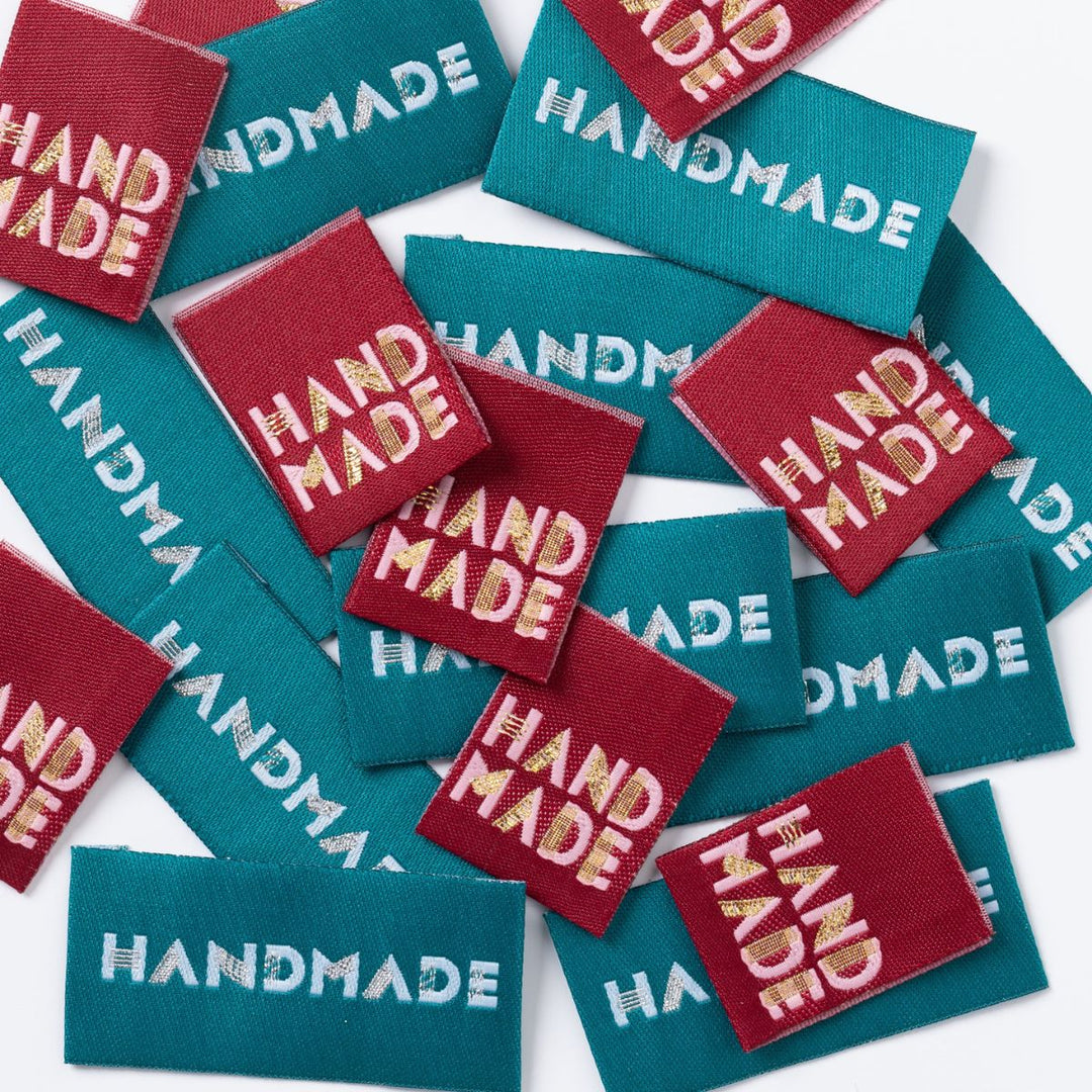 Handmade labels in red and teal on a white background