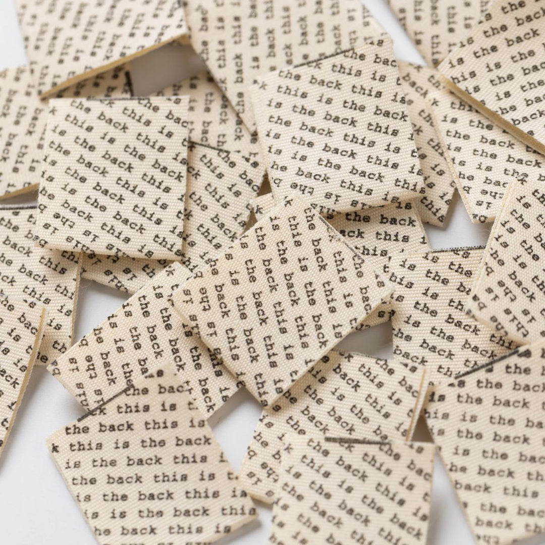 Scattered woven labels with text on a white background