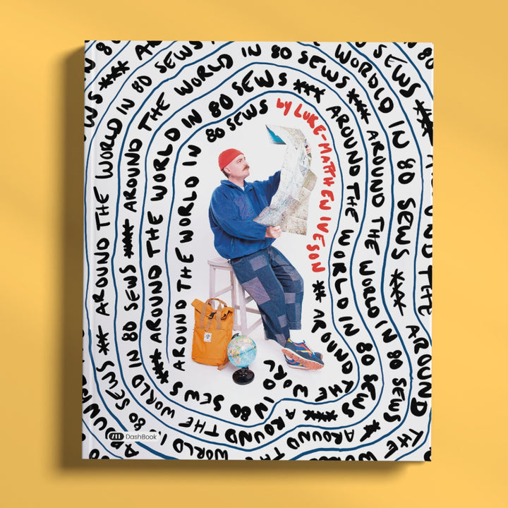 A square art print or poster featuring a stylized illustration of a man sitting on a stool and holding a map, surrounded by concentric circular black text on a white background. The print is displayed against a solid yellow background.