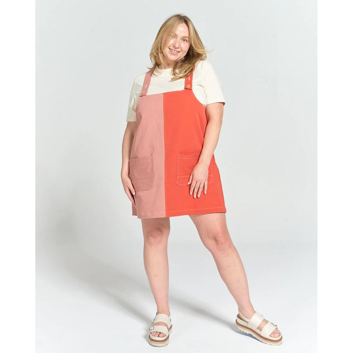 Woman wearing a red and pink striped dress on a white background