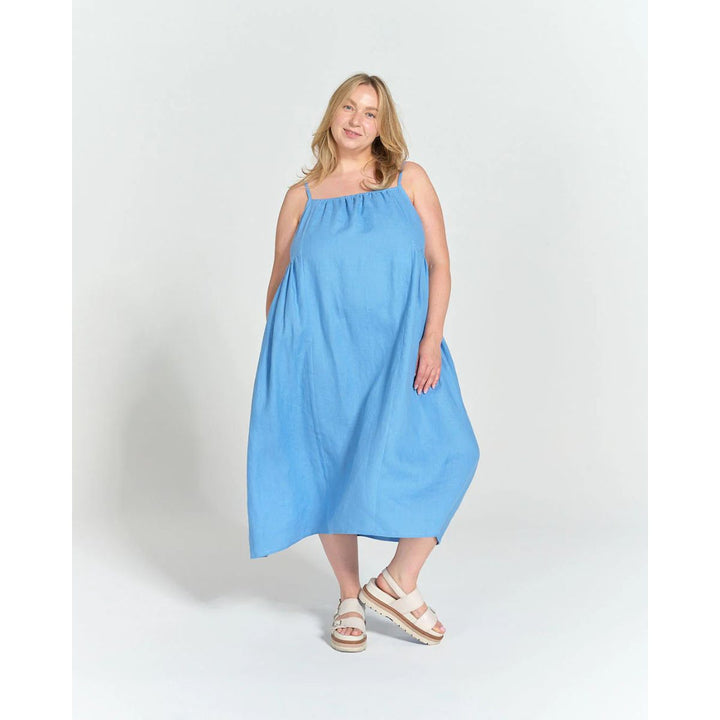 Woman wearing a blue dress on a white background