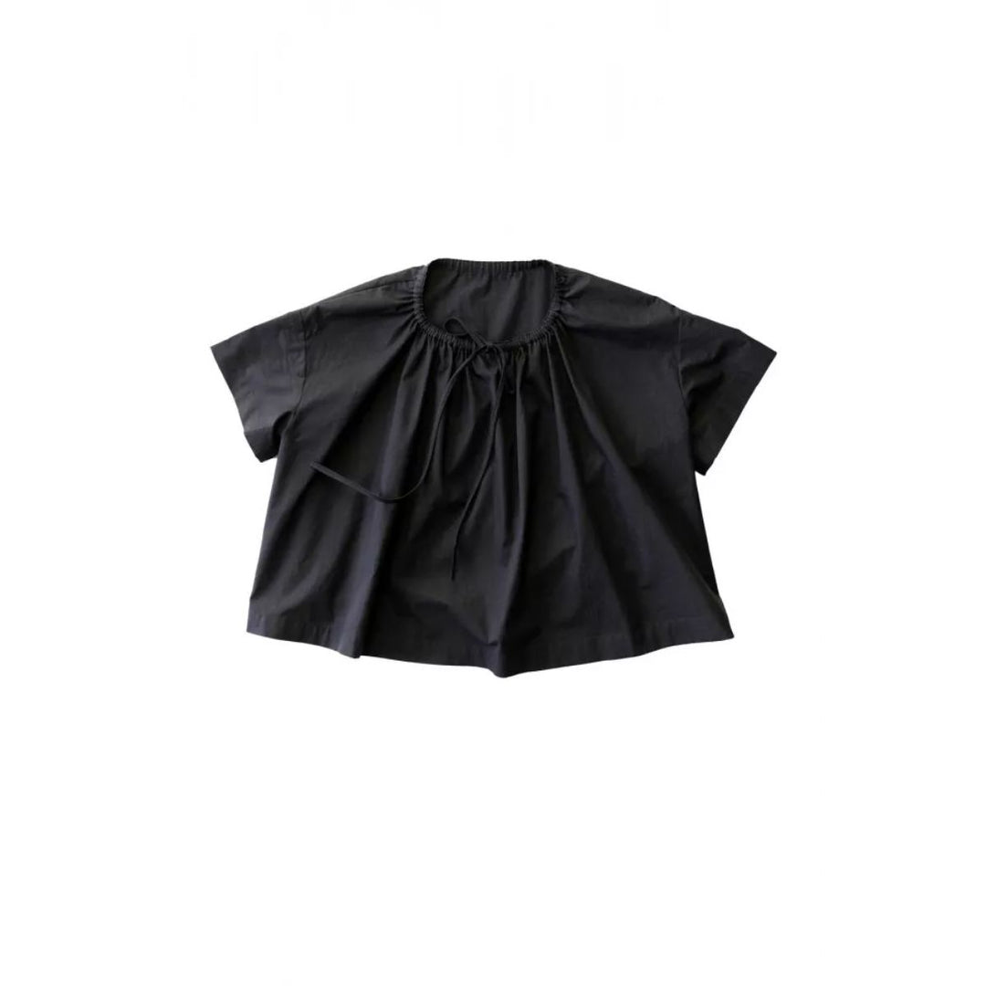 Black blouse with ruffled sleeves on a white background