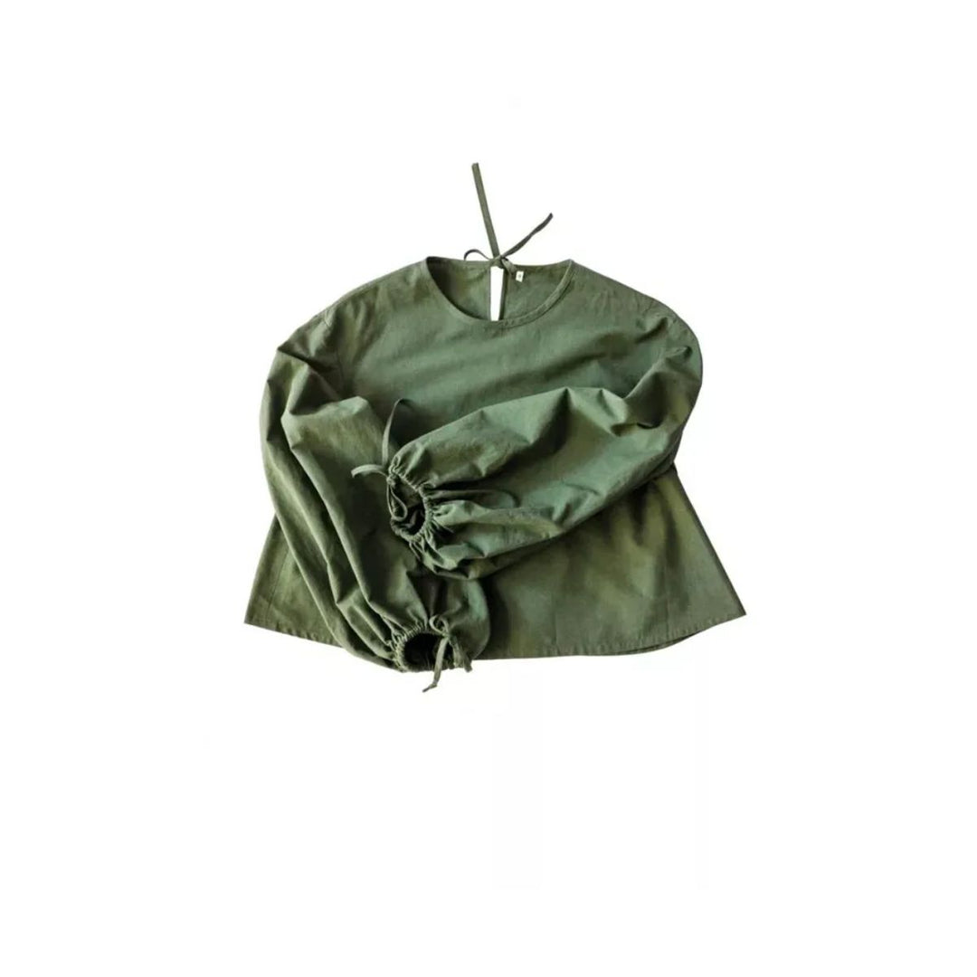 Green blouse with ruffled sleeves on a white background