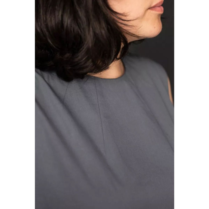 Gray sleeveless top worn by a person with a neutral background