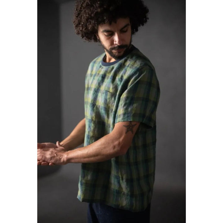 Man wearing a tie-dye t-shirt against a dark background