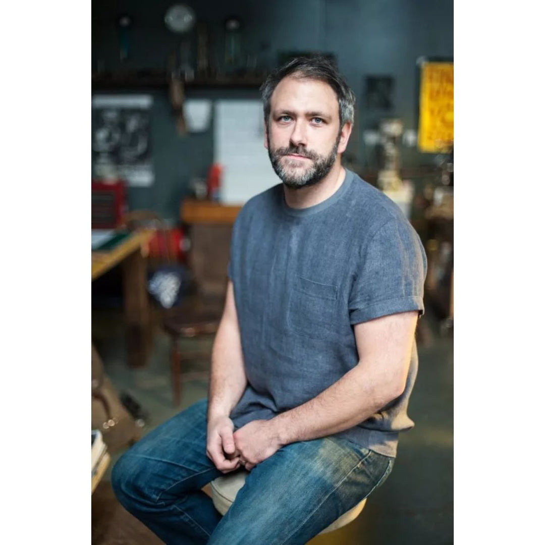 Man sitting in a casual setting with a blurred background