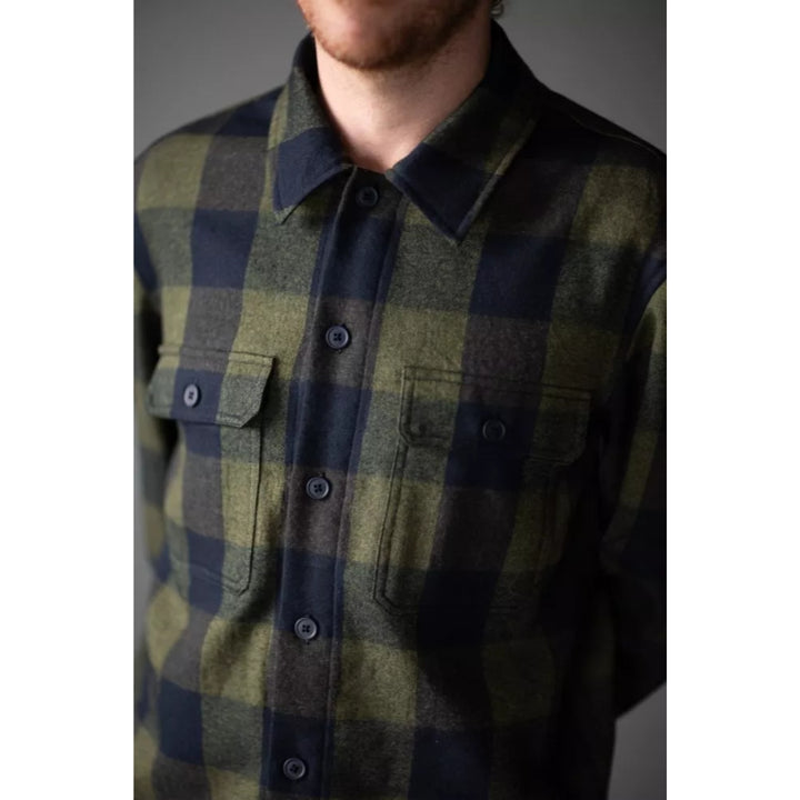 Plaid shirt worn by a person on a plain background