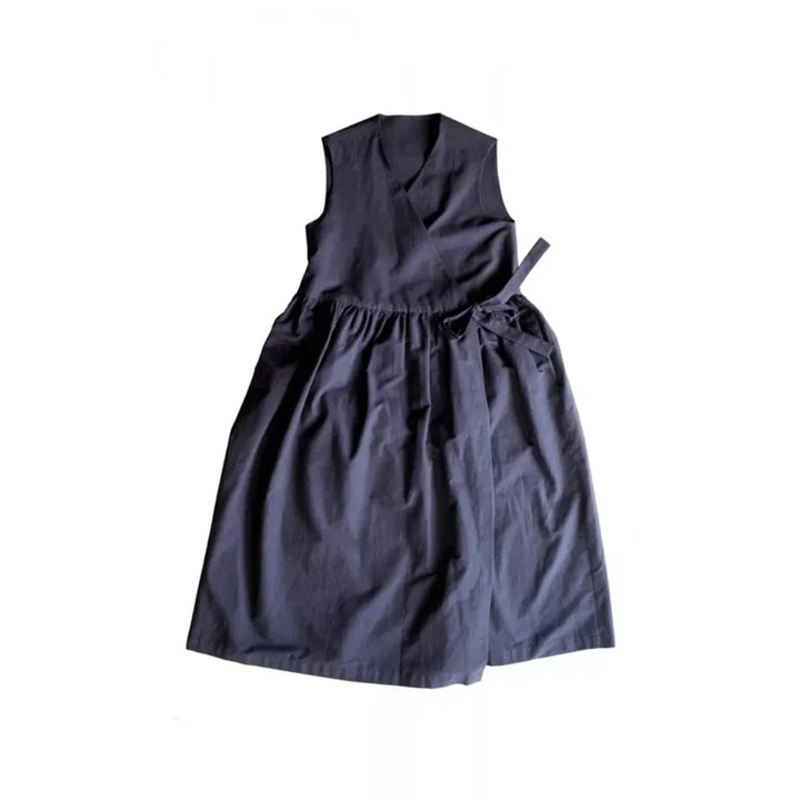 A sleeveless dark navy wrap-style dress with a gathered waist and tie detail, laid flat against a white background.