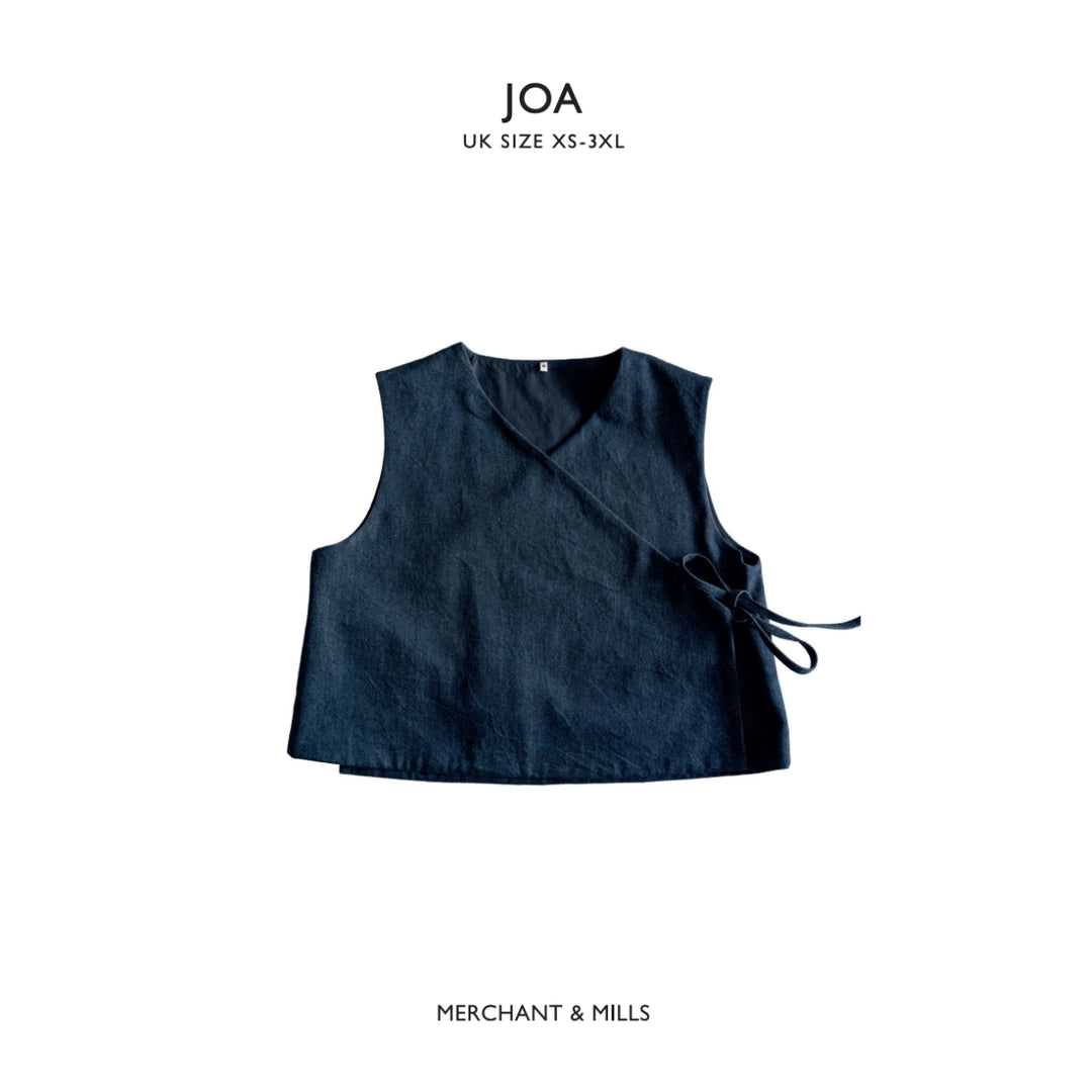 A dark navy blue sleeveless wrap vest with a side tie, shown flat against a white background with 'JOA UK SIZE XS-3XL' text at the top and 'MERCHANT & MILLS' text at the bottom.