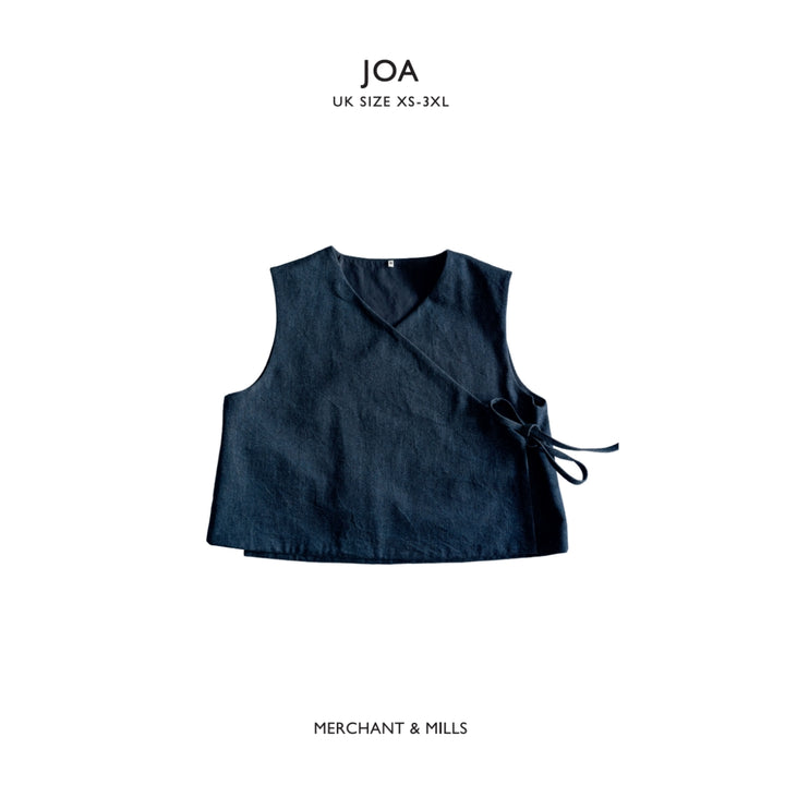 A dark navy blue sleeveless wrap vest with a side tie, shown flat against a white background with 'JOA UK SIZE XS-3XL' text at the top and 'MERCHANT & MILLS' text at the bottom.