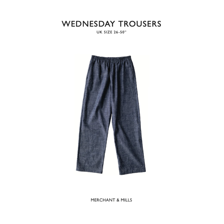 A pair of dark blue denim cropped trousers displayed flat against a white background, with text above reading 'WEDNESDAY TROUSERS' and below reading 'MERCHANT & MILLS'.