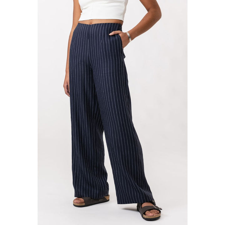 Navy pinstripe pants worn by a person on a white background