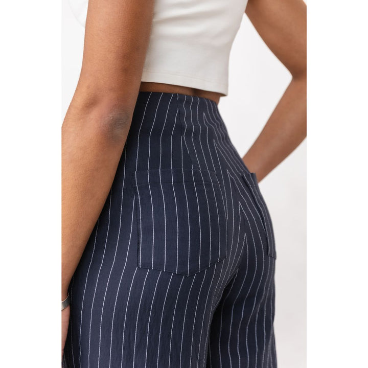 Navy pinstripe pants worn by a person on a white background