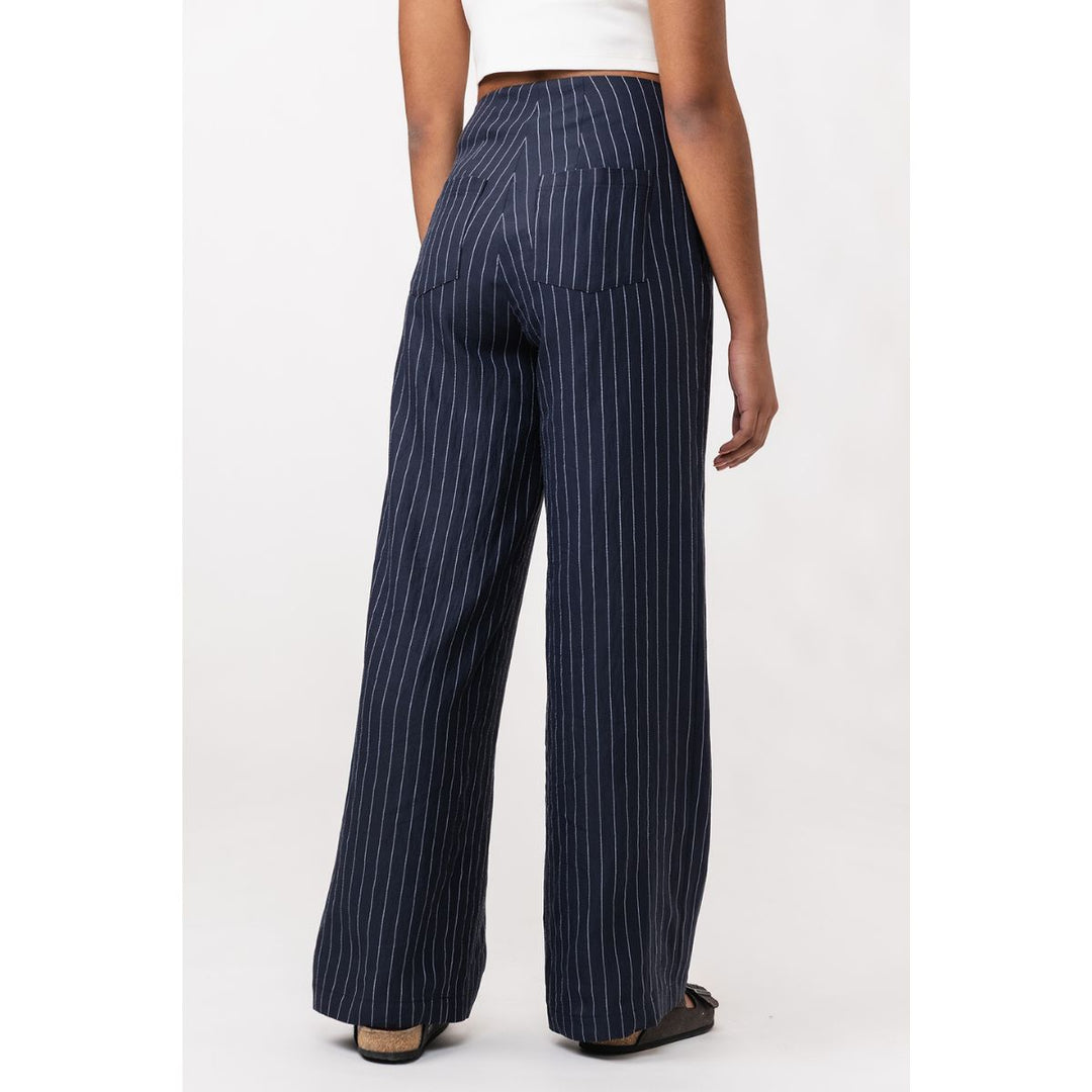 Navy pinstripe pants worn by a person on a white background