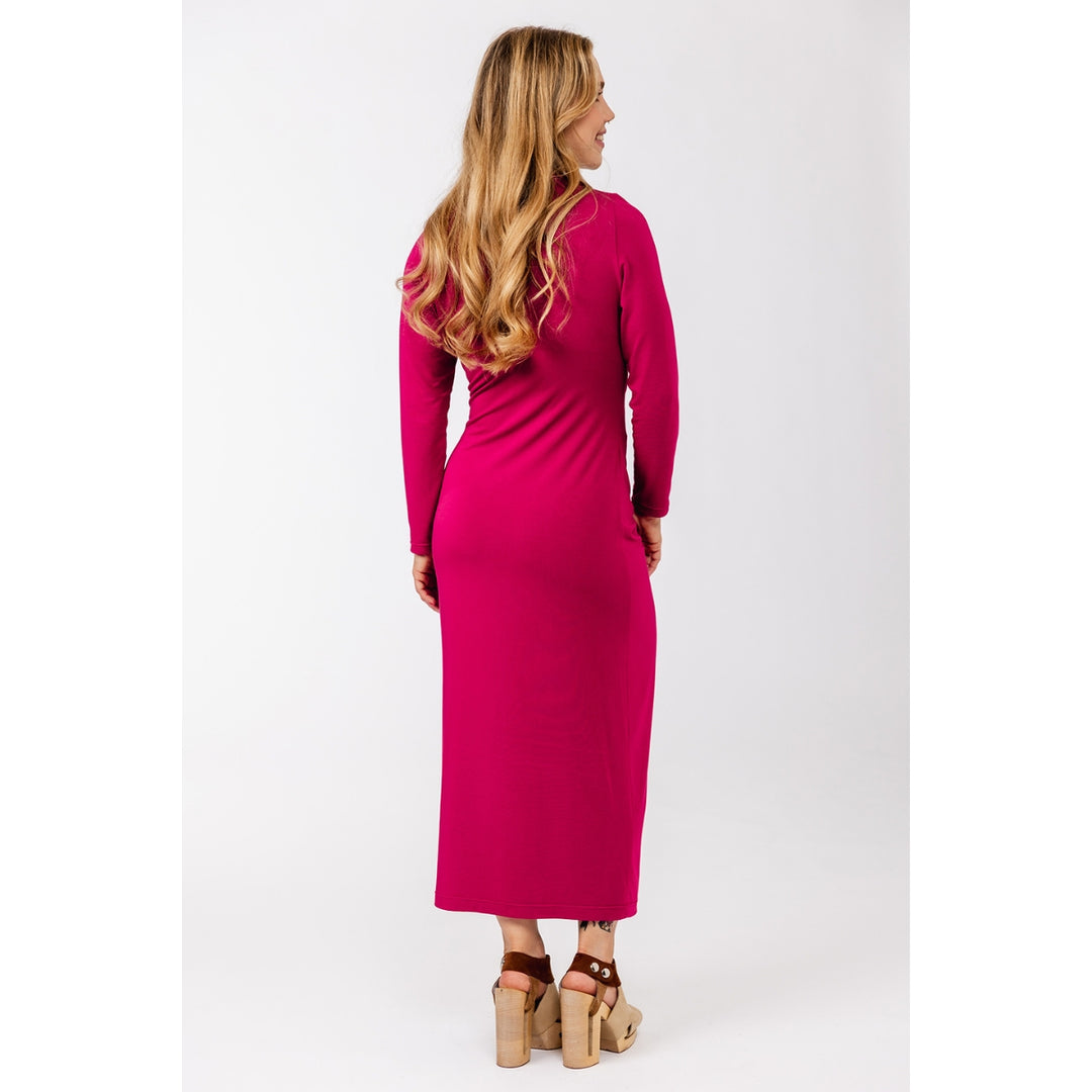 A woman wearing a long-sleeve magenta midi dress, shown from the back and side against a plain white studio background.