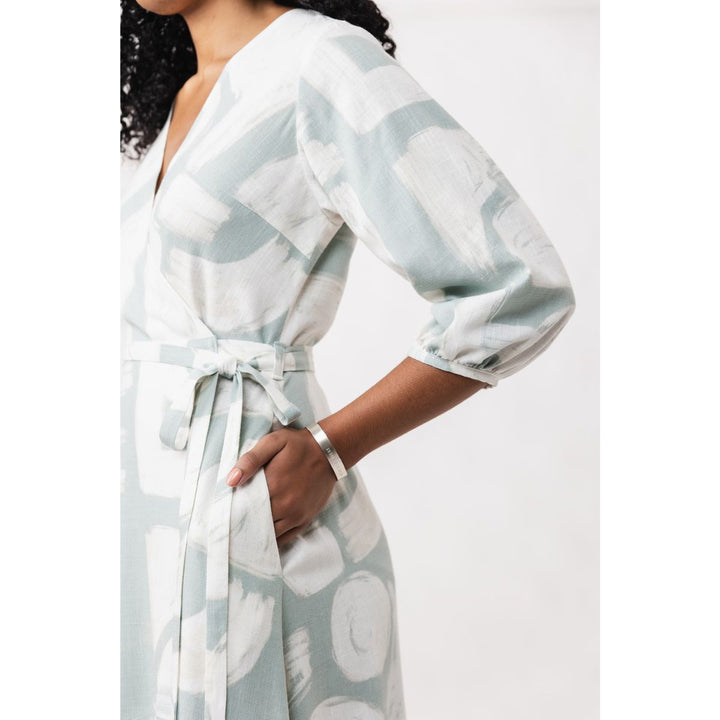 Woman wearing a light blue and white patterned robe against a white background