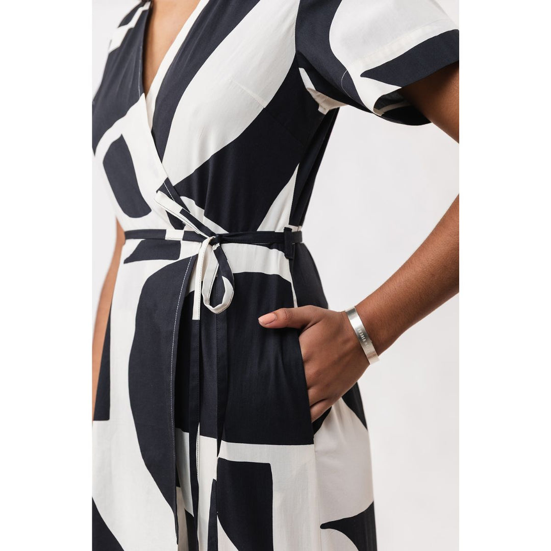 Black and white patterned dress worn by a person on a white background