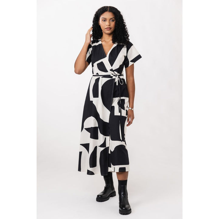 Woman wearing a black and white patterned dress on a white background