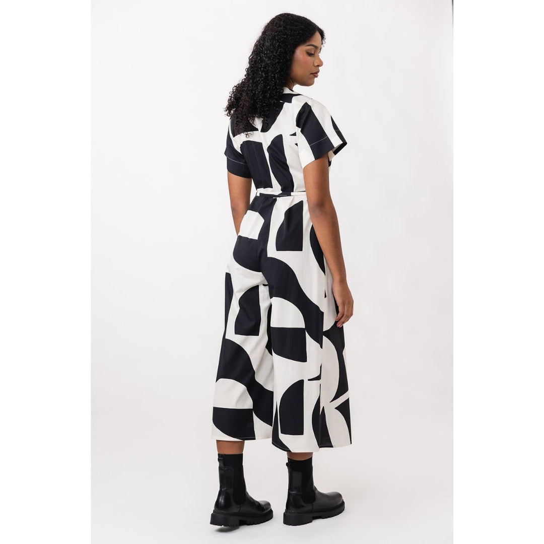 Woman wearing a black and white patterned dress on a white background