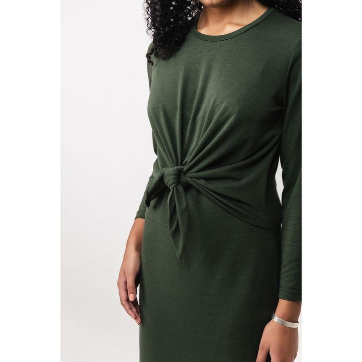 Green dress with a knot detail on a white background