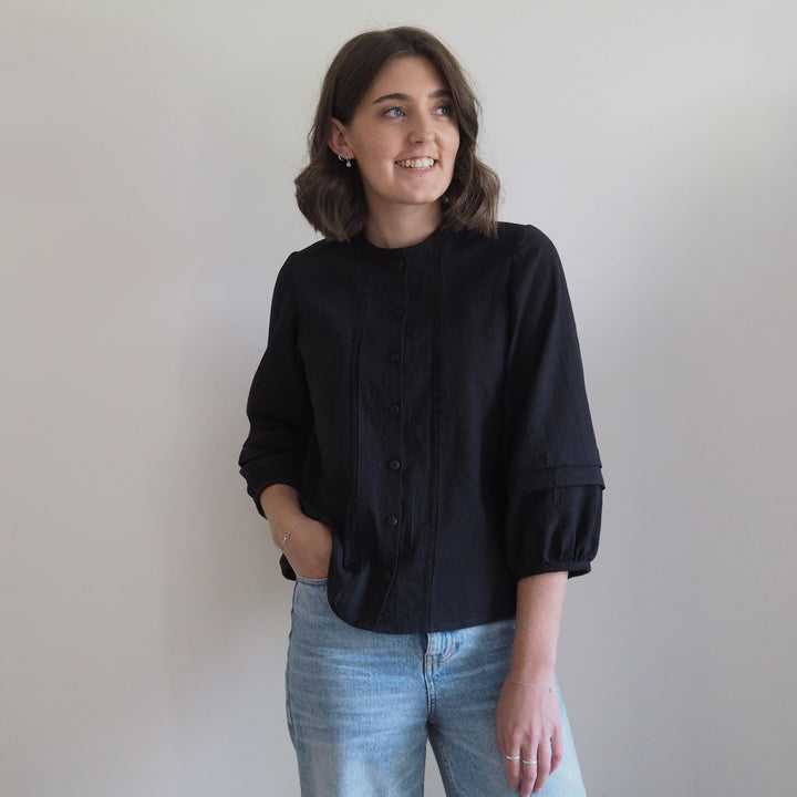 Nepheline blouse sleeve with gathered hem and subtle double pleats.