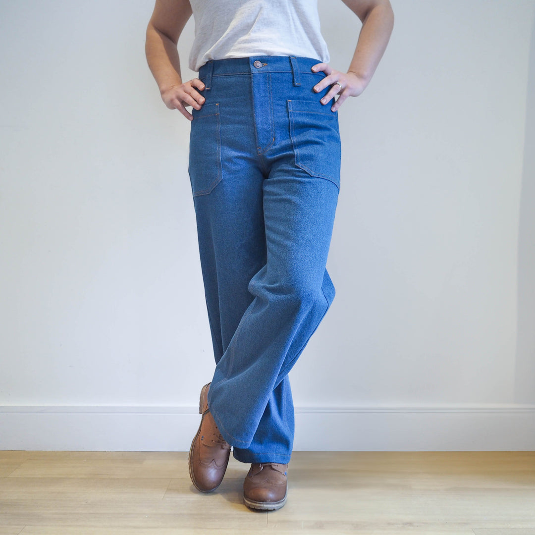 Person wearing the mid blue denim Oxbow trousers with fitted waist and straight leg silhouette