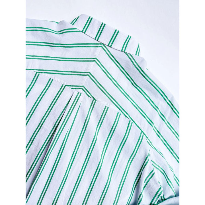 Close-up of a white shirt with green stripes on a white background