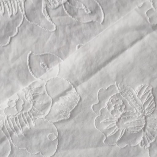 White cotton voile dressmaking fabric with embroidered floral design