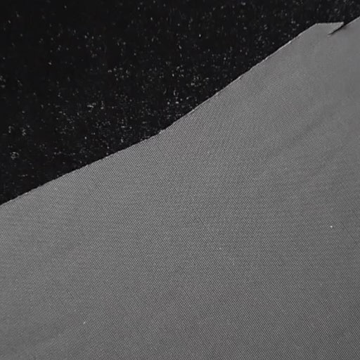 Black stretch velour fabric with soft sheen for dressmaking.