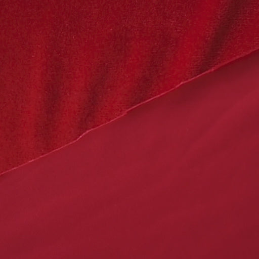 Scarlet red stretch velour fabric with soft sheen for dressmaking.