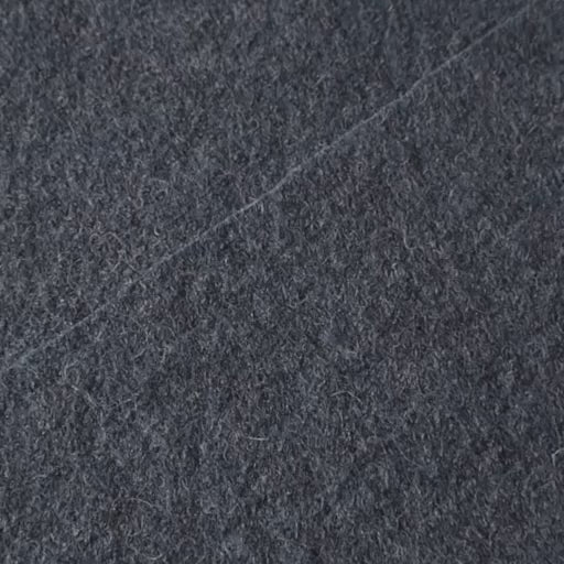 Close up of textured denim blue boiled wool fabric