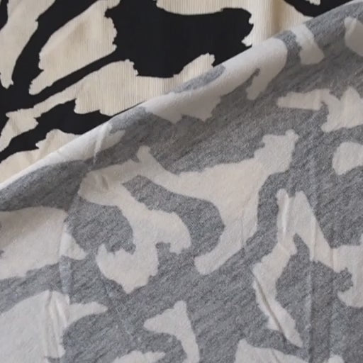 Black and cream stretchy viscose jersey dressmaking fabric with abstract pattern