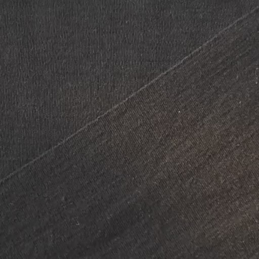 Close-up of black merino wool jersey fabric with visible texture