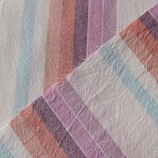 Striped yarn dyed cotton dressmaking fabric in pastel sunset colours