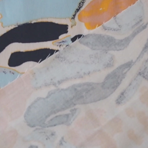 Floral patterned stretch cotton fabric with orange, blue, and black flowers on a light blue background