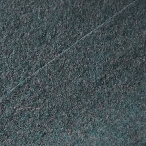 Close up of textured teal boiled wool fabric