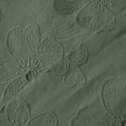 Sage green embroidered cotton dressmaking fabric with floral pattern