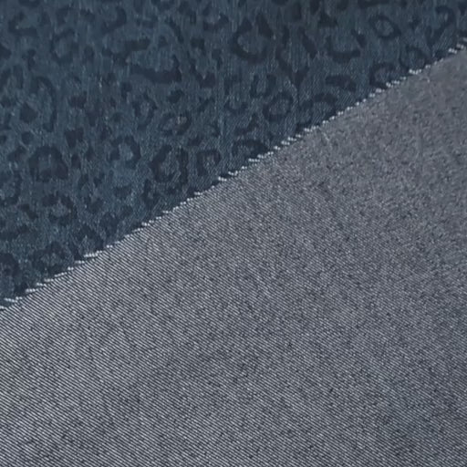 Stretch cotton denim fabric with woven leopard print in indigo blue
