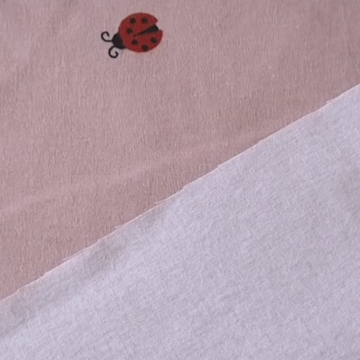 Ladybird Scatter Cotton Flannel Fabric with Red Ladybirds on a mauve pink background