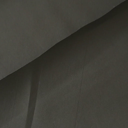 Khaki waxed cotton fabric with water-resistant finish for outerwear sewing.