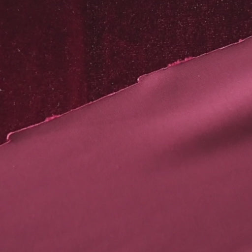 Wine red stretch velour fabric with soft sheen for dressmaking.