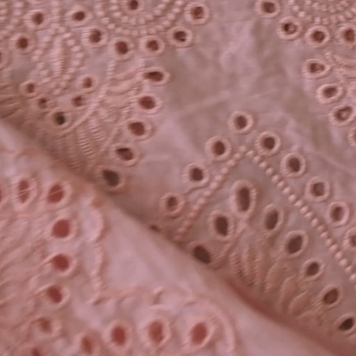 Peachy pink embroidered cupro dressmaking fabric with geometric eyelet pattern