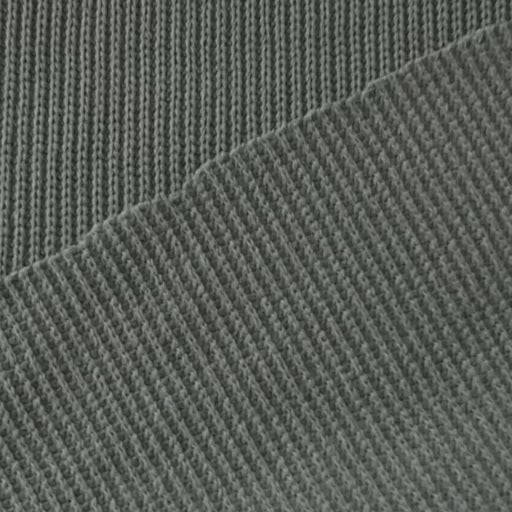 Close-up of sage green ribbed knitted fabric with visible texture