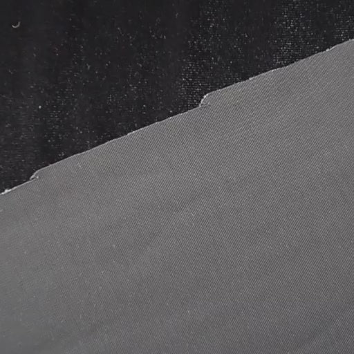 Charcoal grey stretch velour fabric with soft sheen for dressmaking.